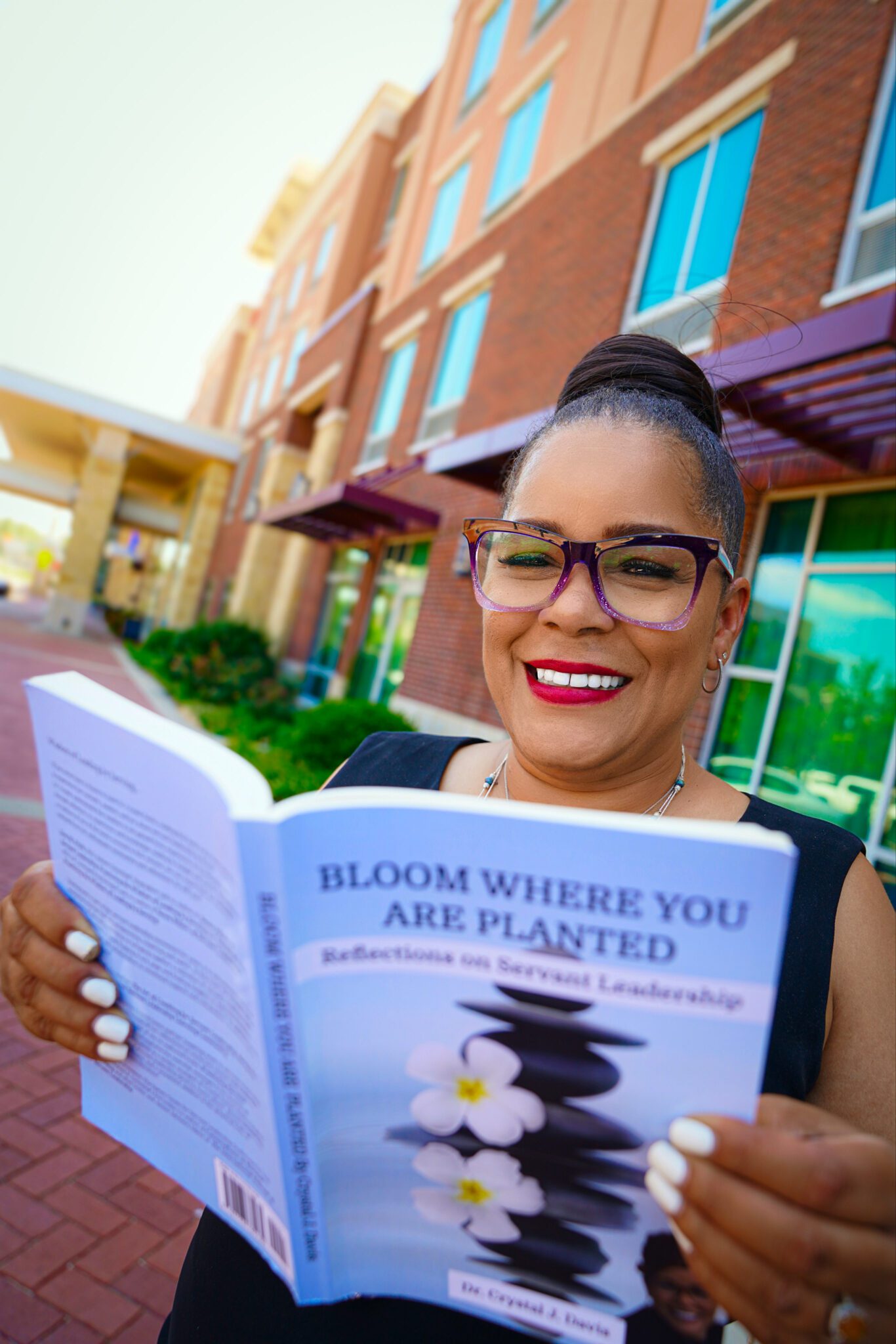 Dr. Crystal Davis holding one of her books